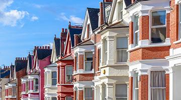 Row of Victorian terrace houses against blue sky