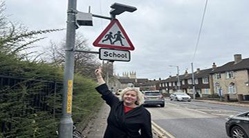 Cllr Dawkins pointing to air sensor